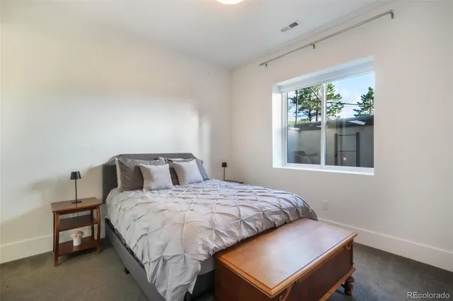 a bedroom with a bed and a night stand