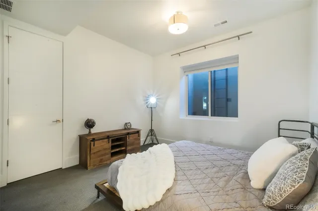 a bedroom with a bed and night stand