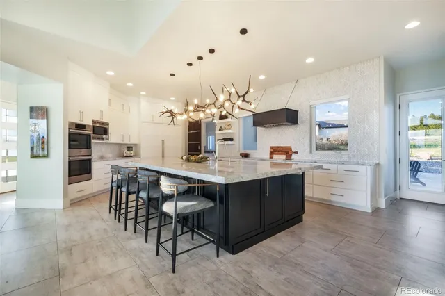 a large kitchen with a table and chairs