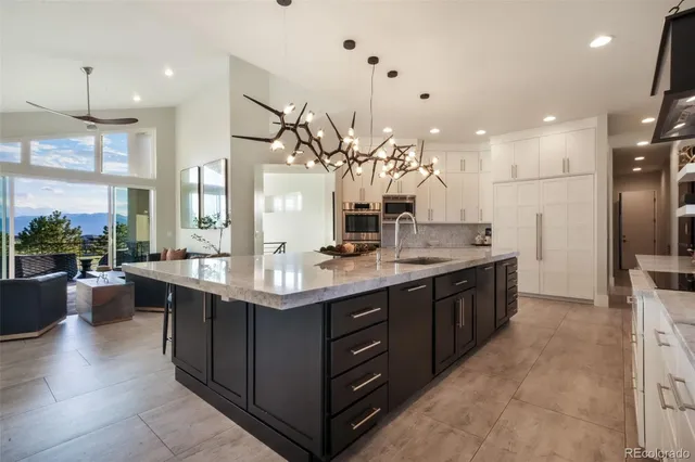 a large kitchen with a large counter top appliances and cabinets