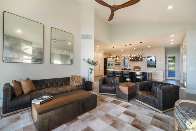 a view of a living room kitchen and a chandelier