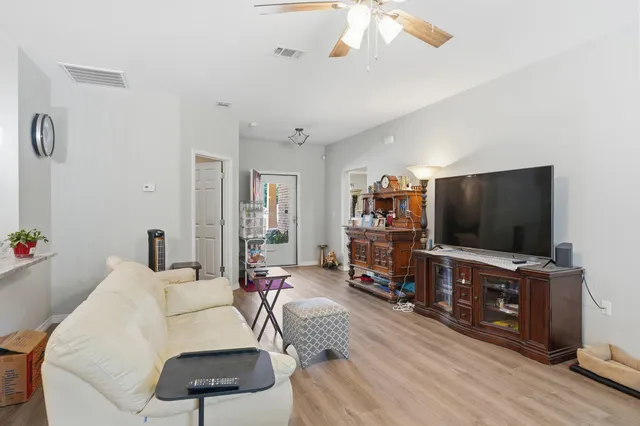 a view of a dining room with furniture and wooden floor