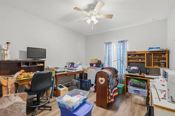 a bathroom with a granite countertop toilet a sink and a large mirror