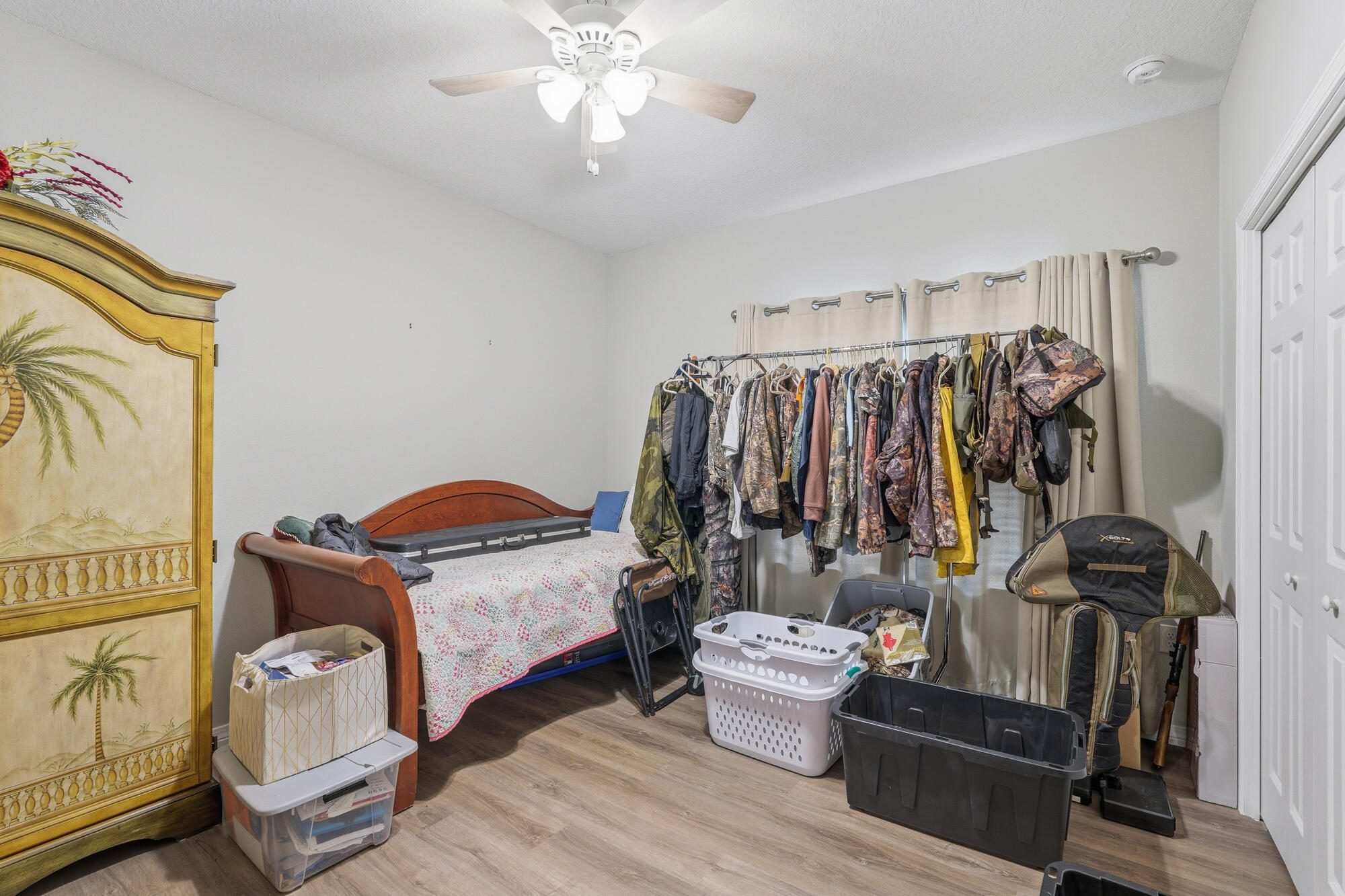 2012 North Pearl Street Crestview, FL 32536 - Photo 16 of 25 a view of walk in closet with clothes and shoes