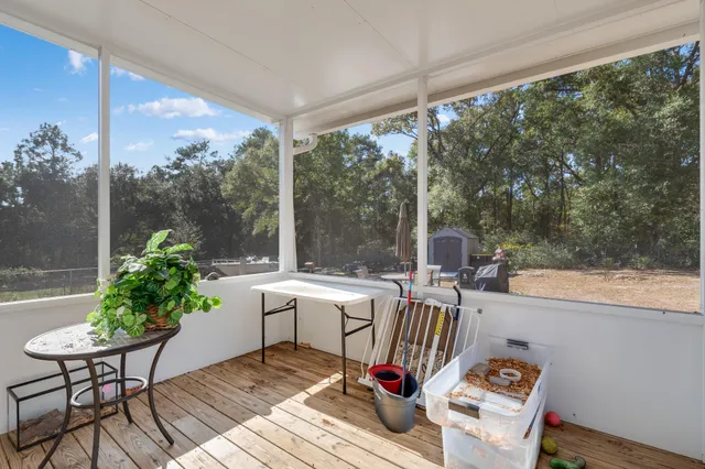 a view of a porch with furniture and a yard