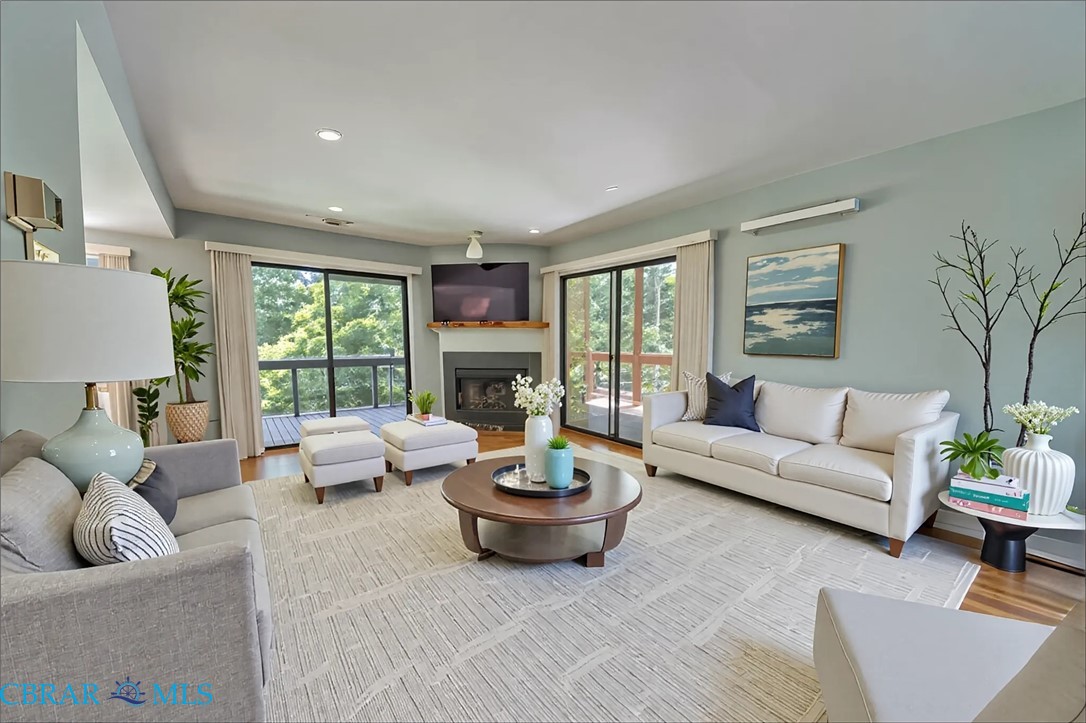 54 Villa Ridge Drive, Unit C Hartfield, VA 23071 - Photo 23 of 45 Living area featuring wood finished floors, a glass covered fireplace, and recessed lighting