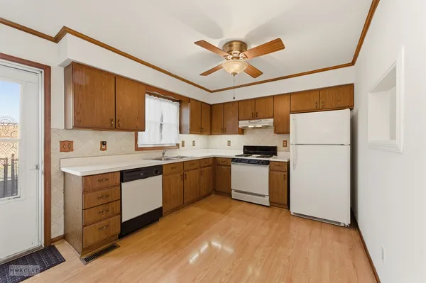 a kitchen with a refrigerator sink and cabinets