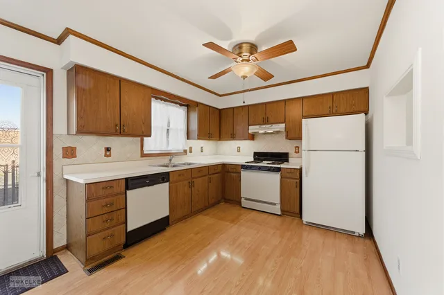 a kitchen with a refrigerator sink and cabinets