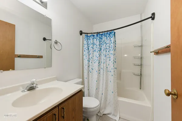 a bathroom with a sink toilet tub and shower