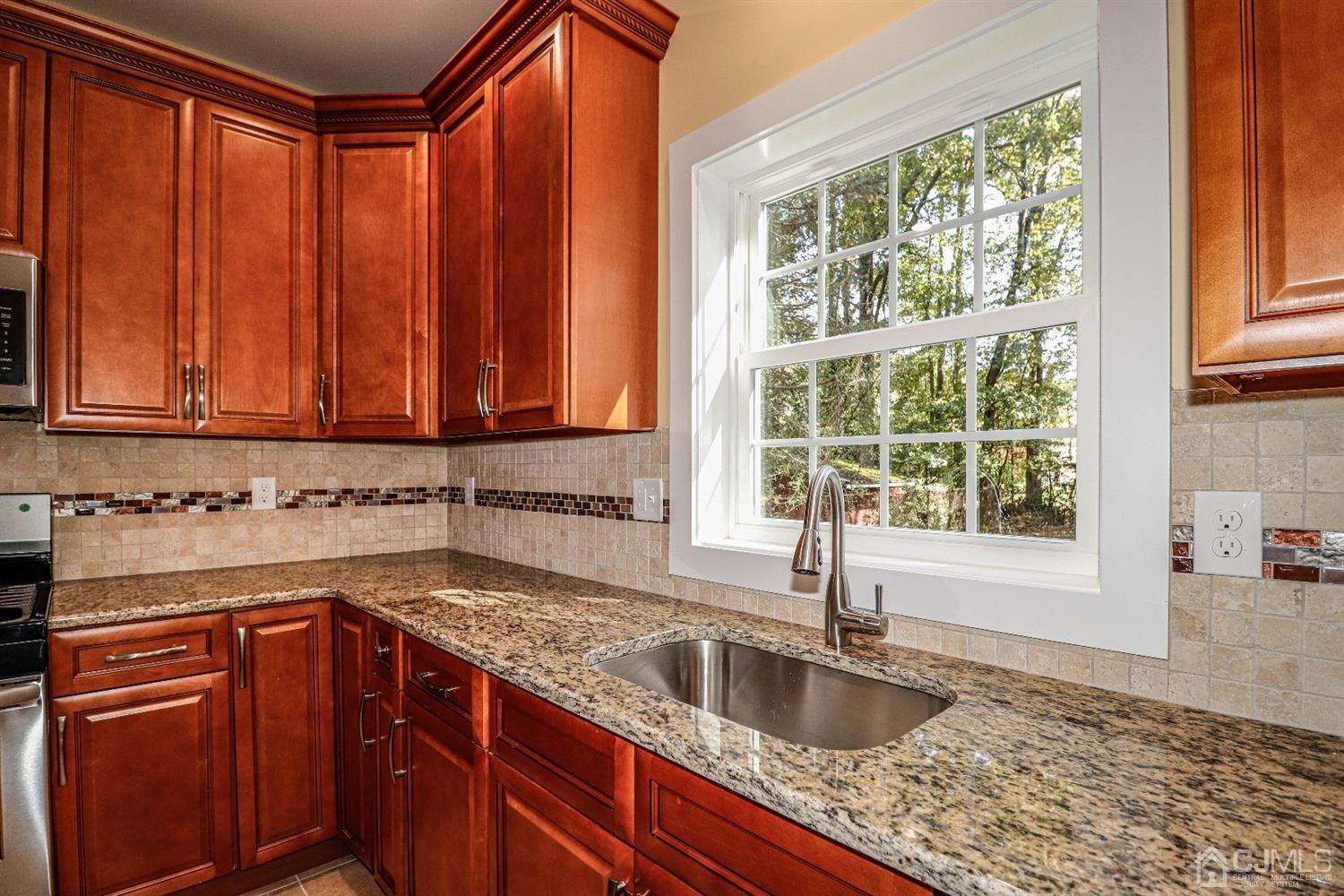 1834 Oak Road North Brunswick, NJ 08902 - Photo 11 of 39 Close up view of counters, sink, backsplash and window in this spectacular kitchen.