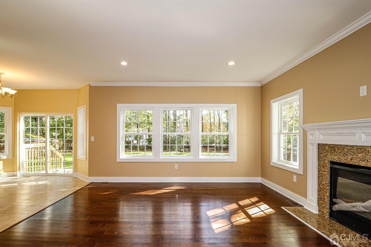 1834 Oak Road North Brunswick, NJ 08902 - Photo 15 of 39 Relaxing family room with lots of windows, wood flooring, recessed lights and gas fireplace.