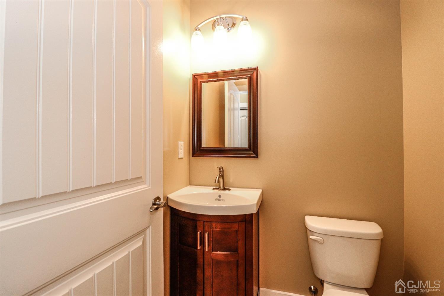 1834 Oak Road North Brunswick, NJ 08902 - Photo 19 of 39 Half bath with ceramic tile flooring, vanity sink and decorative mirror.