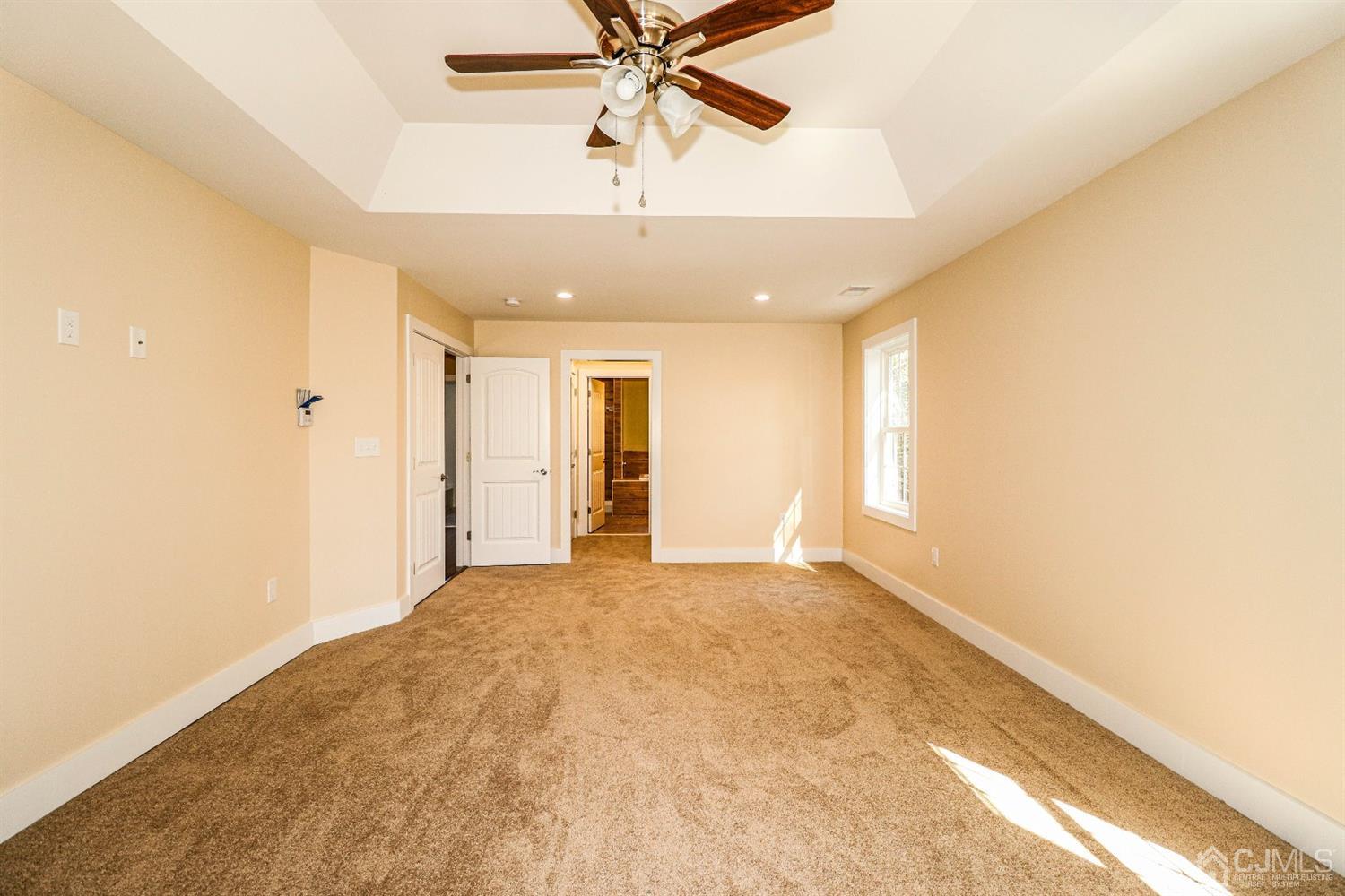 1834 Oak Road North Brunswick, NJ 08902 - Photo 22 of 39 King sized master bedroom with tray ceilings, recessed lighting, ceiling fan and wall to wall carpeting.