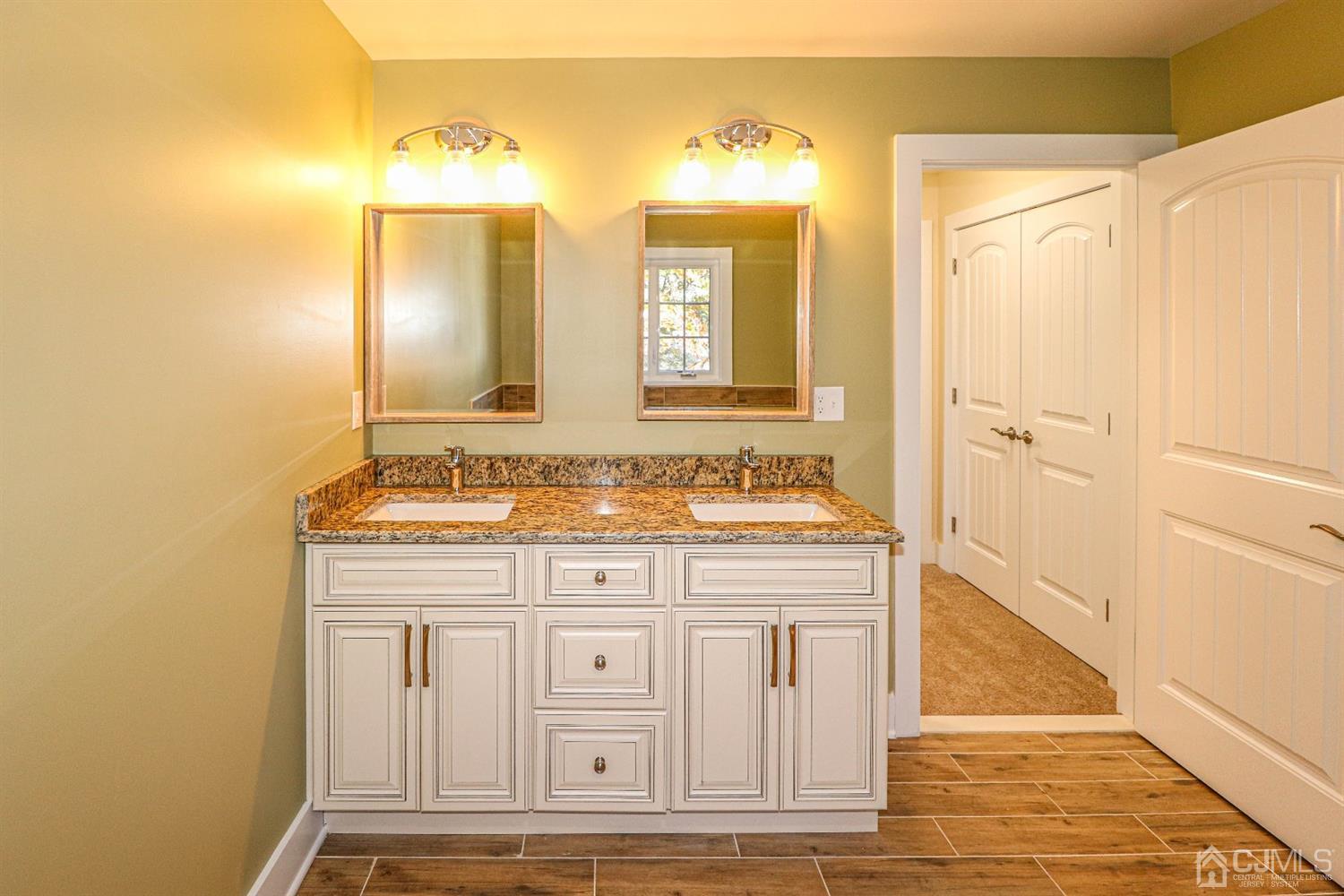 1834 Oak Road North Brunswick, NJ 08902 - Photo 25 of 39 Double vanity sink with granite counter top, mirrors and lights above.