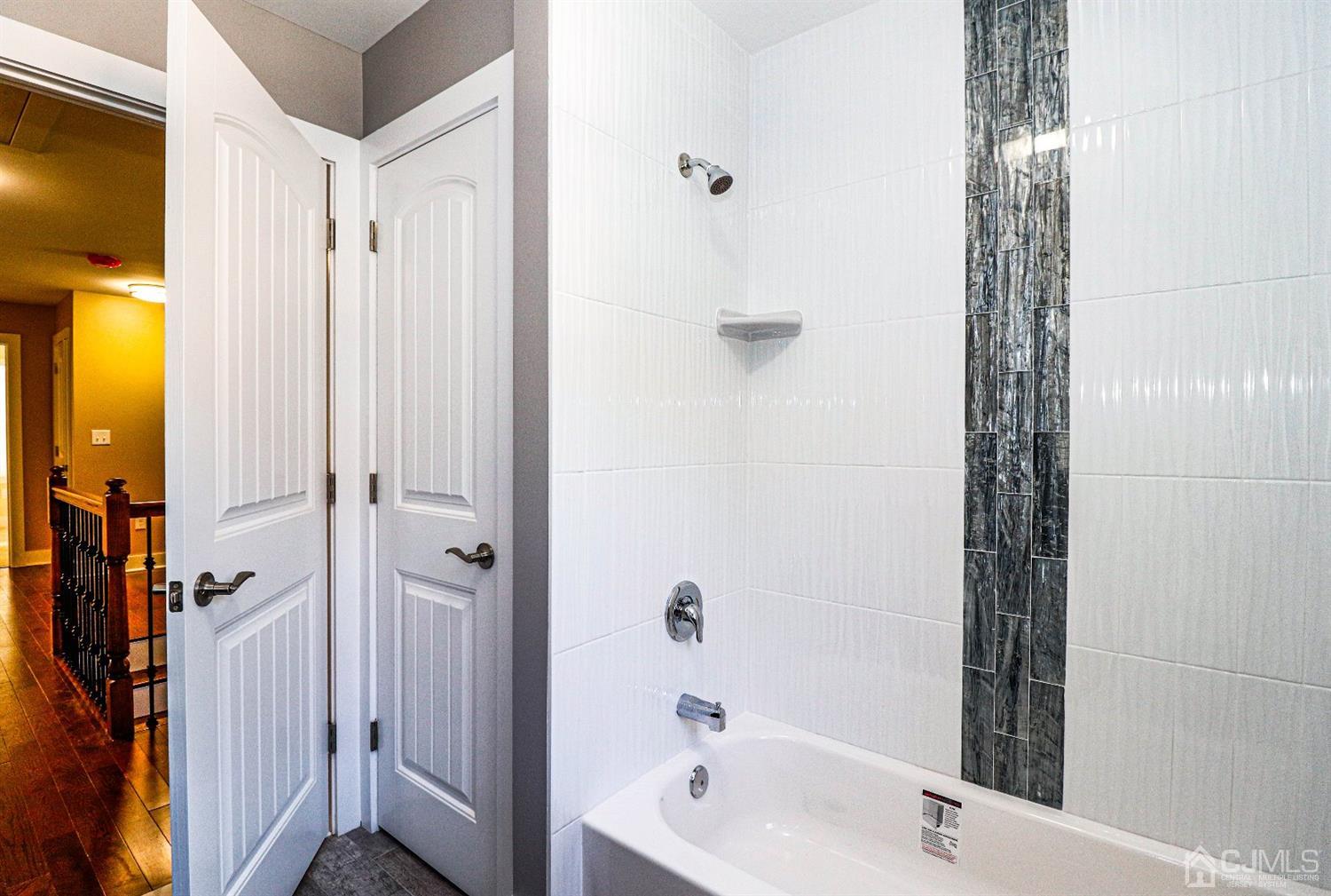 1834 Oak Road North Brunswick, NJ 08902 - Photo 33 of 39 Main bathroom, tiled tub area and linen closet inside the bathroom.