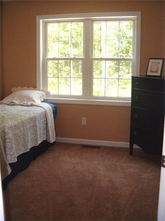 197 Fisherdick Road Ware, MA 01082 - Photo 22 of 30 a bed sitting in a bedroom next to a window
