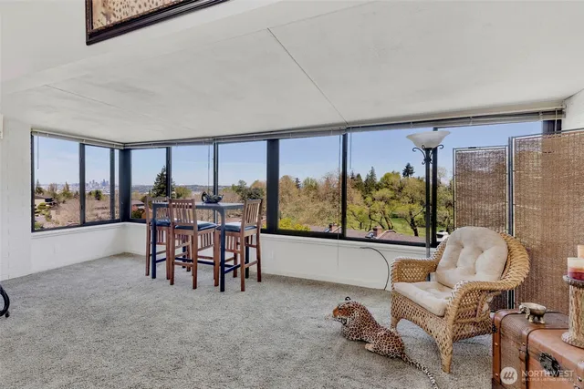 a dining room with furniture and a floor to ceiling window