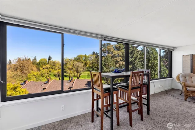 a view of a city from a dining room with large windows