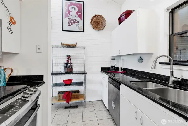 a kitchen with stainless steel appliances granite countertop a sink and a stove