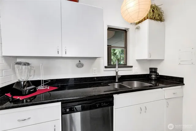 a kitchen with a sink a stove and cabinets