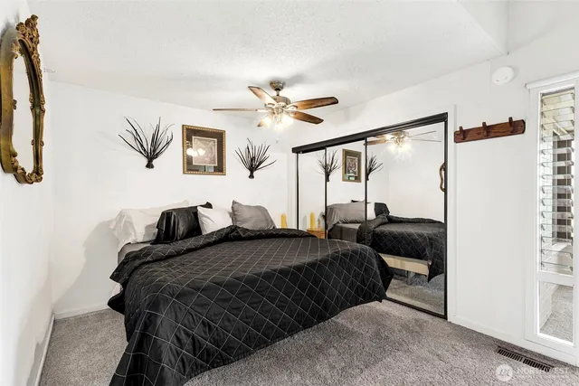 a bedroom with bed and a chandelier
