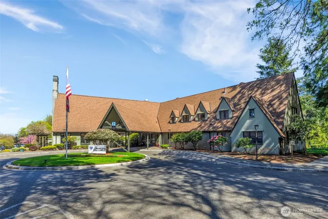 a room with lots of tables a large window and chairs