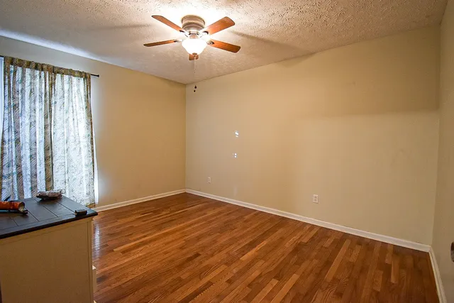 wooden floor in an empty room with a window