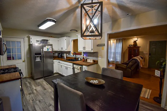 a kitchen with stainless steel appliances granite countertop a sink refrigerator and stove