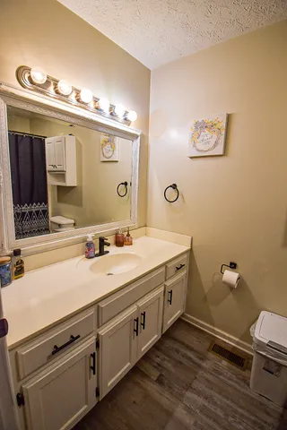 a spacious bathroom with a double vanity sink and a mirror