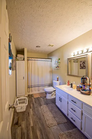 a spacious bathroom with a double vanity sink mirror and bathtub
