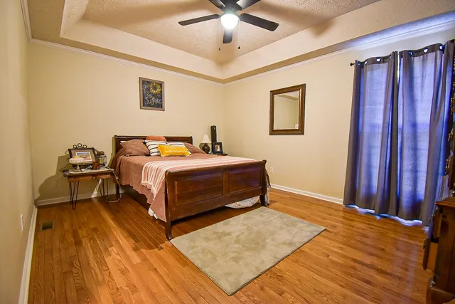 a bedroom with a bed and a chandelier