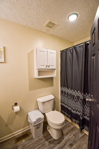 a bathroom with a toilet a sink and bathtub