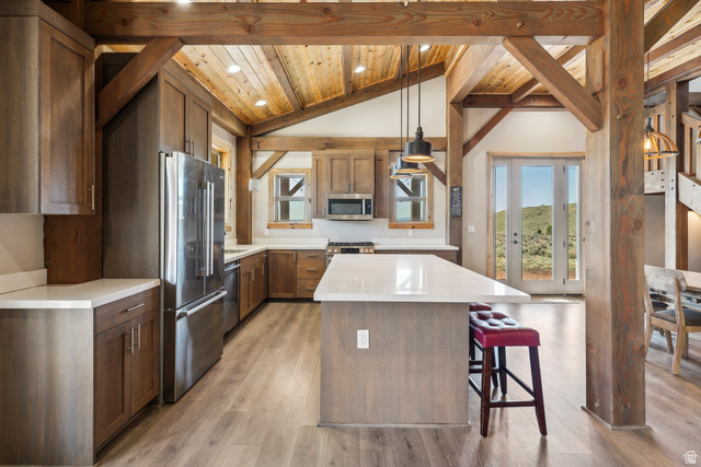 46997 West Thunder Road Fruitland, UT 84027 - Photo 5 of 49 Kitchen with appliances with stainless steel finishes, hanging light fixtures, a kitchen island, light wood finished floors, and a breakfast bar