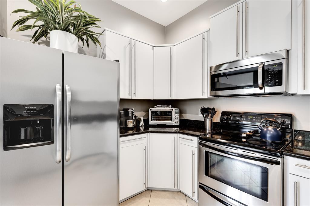 1224 Northeast 18th Avenue, Unit 1 Fort Lauderdale, FL 33304 - Photo 12 of 34 a kitchen with stainless steel appliances white cabinets and a stove top oven