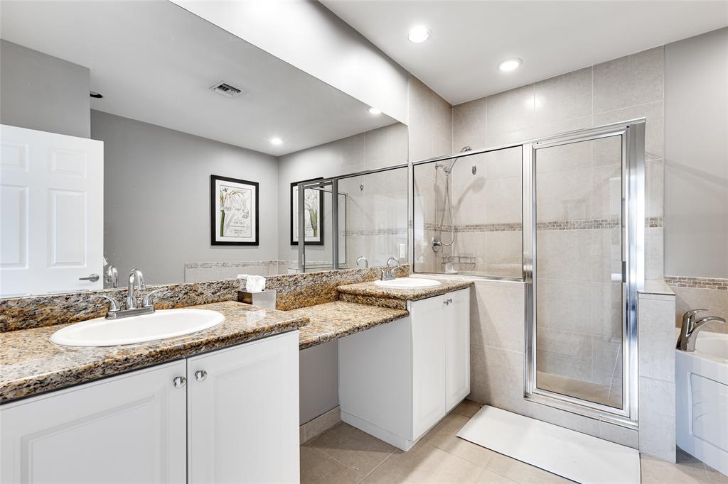 1224 Northeast 18th Avenue, Unit 1 Fort Lauderdale, FL 33304 - Photo 17 of 34 a bathroom with a granite countertop sink mirror and double