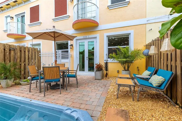 a outdoor space with lots of chairs and a table