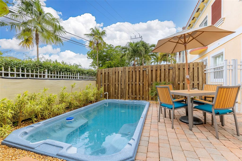 1224 Northeast 18th Avenue, Unit 1 Fort Lauderdale, FL 33304 - Photo 3 of 34 a view of swimming pool with a patio and a garden