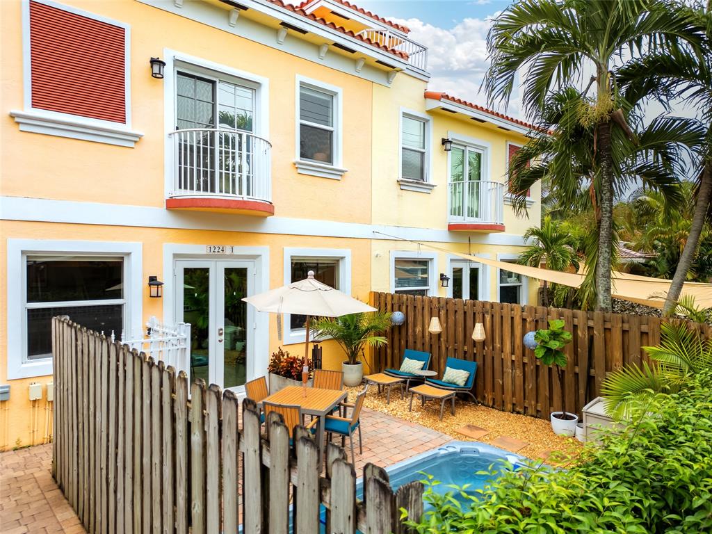 1224 Northeast 18th Avenue, Unit 1 Fort Lauderdale, FL 33304 - Photo 4 of 34 a view of a house with a patio and a yard