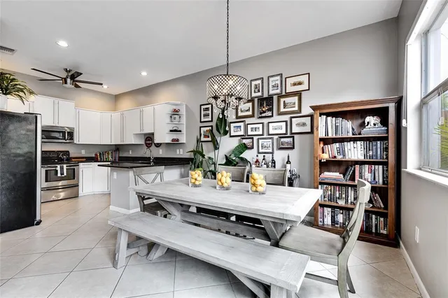 a kitchen with stainless steel appliances white cabinets and a stove top oven