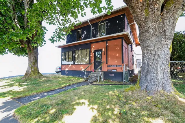a view of a house with a yard balcony and sitting area