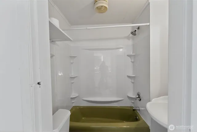 a bathroom with a tub and toilet