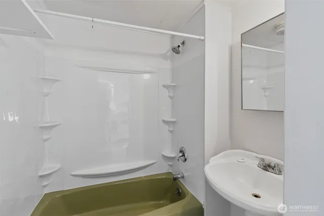 a bathroom with a tub and shower