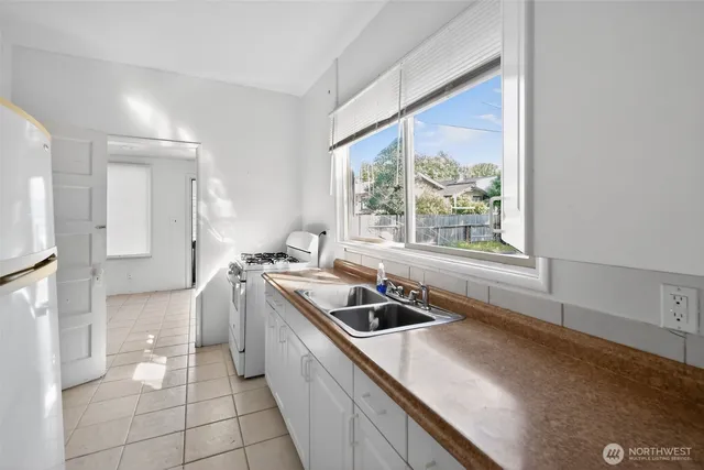 a kitchen with a sink and a stove top oven