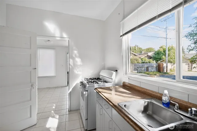 a kitchen with a sink cabinets and a large window
