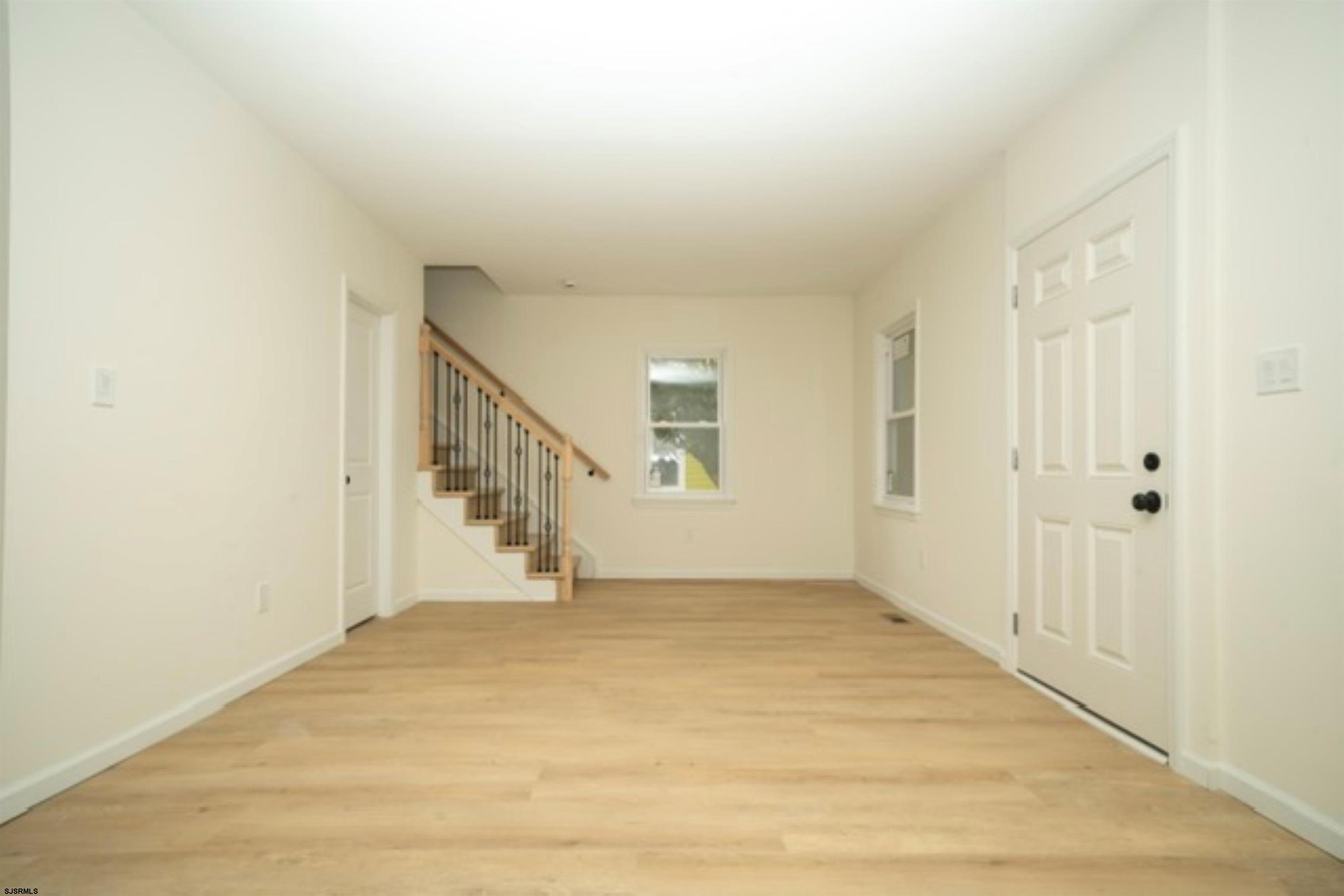 115 Ryon Avenue Pleasantville, NJ 08232 - Photo 2 of 12 a view of an empty room with wooden floor