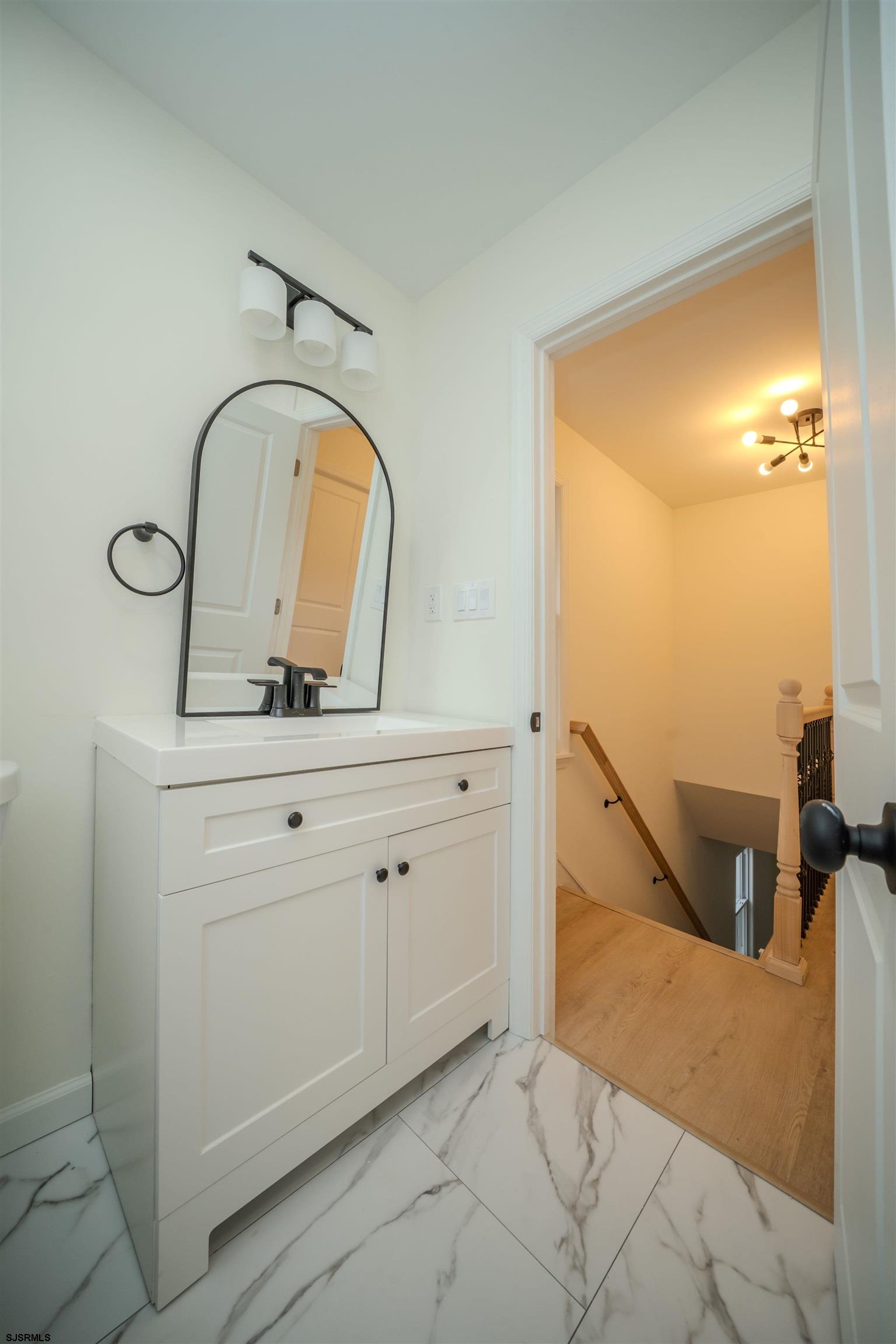 115 Ryon Avenue Pleasantville, NJ 08232 - Photo 6 of 12 a bathroom with a sink and mirror