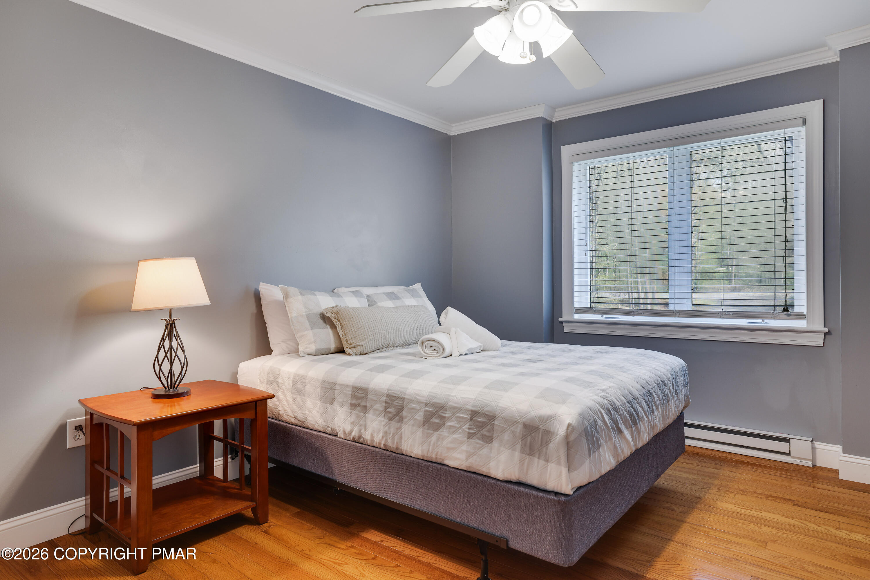 659 Behrens Road Jim Thorpe, PA 18229 - Photo 34 of 57 a bedroom with a bed a lamp and a large window