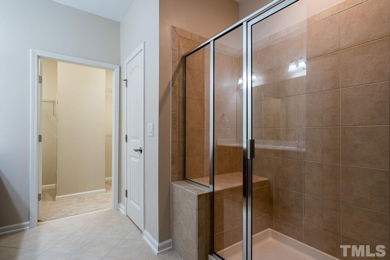 4713 Gaelic Trail Raleigh, NC 27604 - Photo 20 of 26 a bathroom with a glass shower door