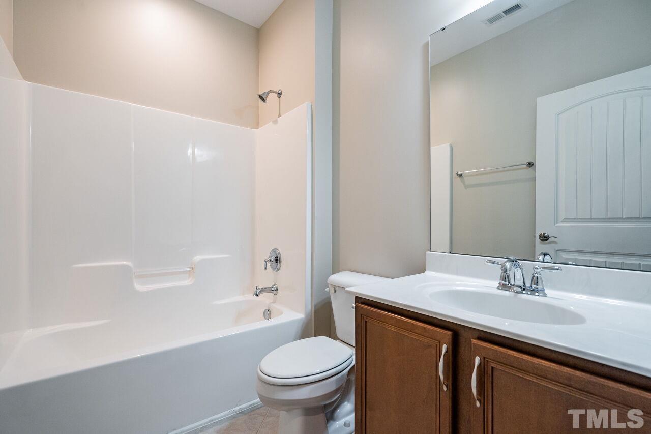 4713 Gaelic Trail Raleigh, NC 27604 - Photo 24 of 26 a bathroom with a sink a toilet and shower