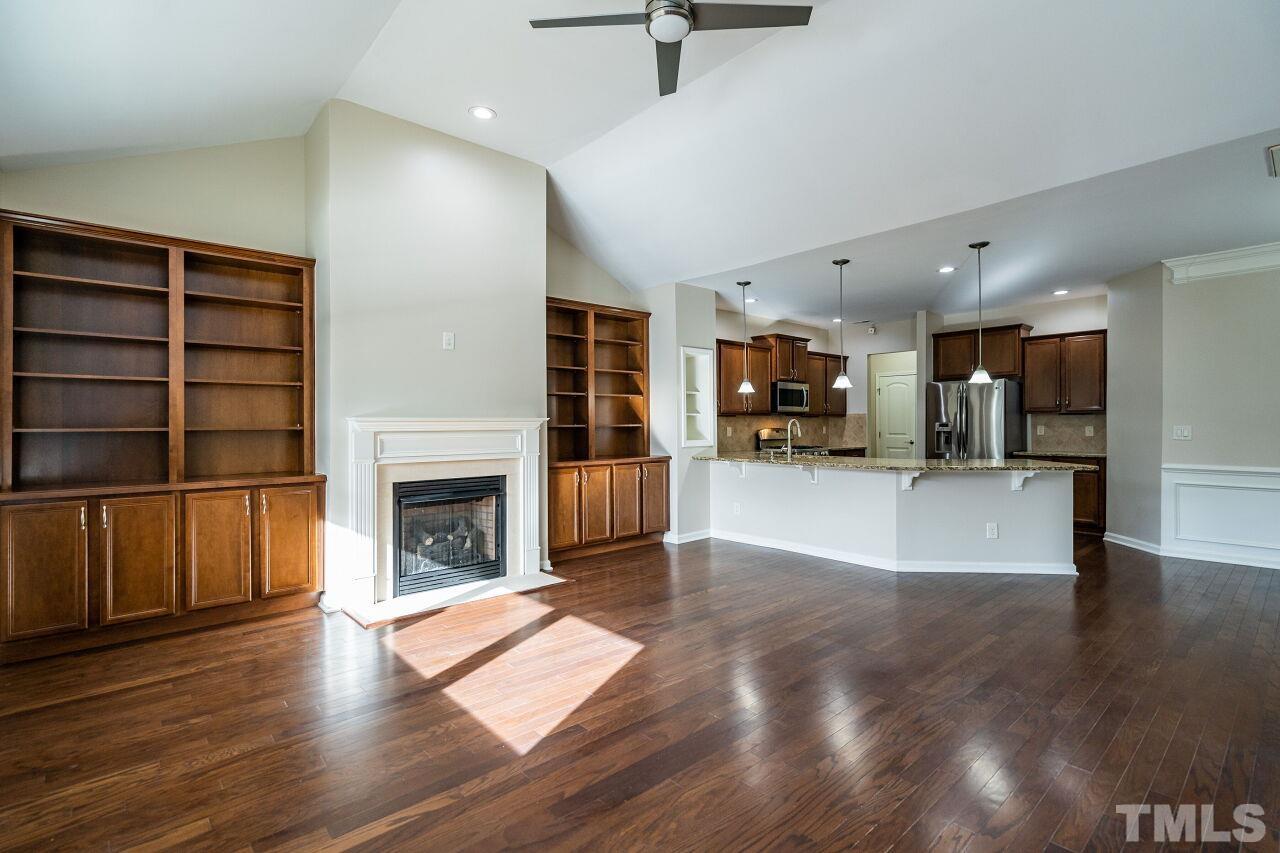 4713 Gaelic Trail Raleigh, NC 27604 - Photo 5 of 26 a view of a living room a refrigerator and a fireplace